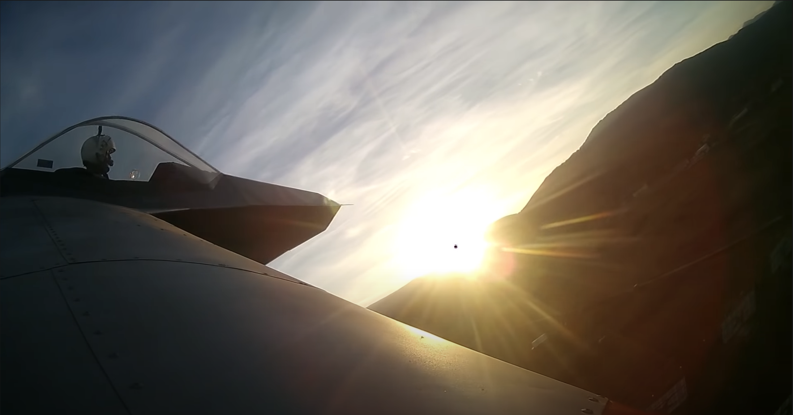 Photo looking down of an SF-1 Archon flying over cultivated fields.